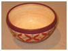 A Bali stoneware bowl, decorated with geometric design with 4 leaves on peach colour background - second view.