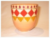 A Bali stoneware vase, decorated with 3 rows of diamond shapes in autumn colours on peach background  - first view.