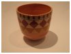 A Bali stoneware vase, decorated with 3 rows of diamond shapes in autumn colours on peach background  - third view.