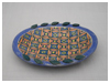 A Bali stoneware oval plate, decorated with a complex geomatric design using colourful glazes - first view.