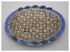 A Bali stoneware oval plate, decorated with a complex geomatric design using colourful glazes - second view.