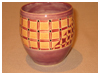 A Bali stoneware vase, decorated with a wickers basket style geometric design - third view.