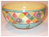 A Bali stoneware bowl, decorated with geometric pattern with flowers in pastel colours - first view.