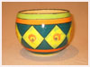 A Bali stoneware jardiniere, decorated with daffodils in diamond shapes and green and orange borders - first view.