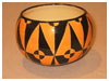 A Bali stoneware geometric design bowl, decorated in triagles using black and orange glazes - third view.