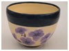 A Bali stoneware bowl, glazed with purple petunia with blue border - first view.