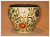 A Bali stoneware jardniere, decorated with colourful daisy flowers and green leaves - first view.