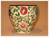 A Bali stoneware jardniere, decorated with colourful daisy flowers and green leaves - third view.