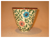 A Bali stoneware vase, decorated with large daisies and leaves - third view.