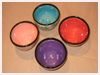 A Bali stoneware set of 4 bowls decorated in different colours with little flowers - second view.