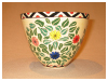 A Bali stoneware bowl, decorated with colourful daisies and leaves - second view.