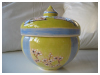 A Bali stoneware pot with lid, decorated with Chinese fans and spring flowers - third view.