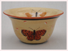 A Bali stoneware pot, glazed with 6 large butterflies on cream colour background - first view.